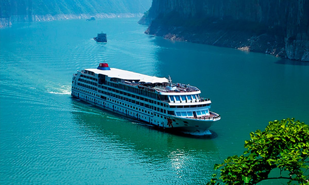 Three Gorges cruise ship sailing between mountains